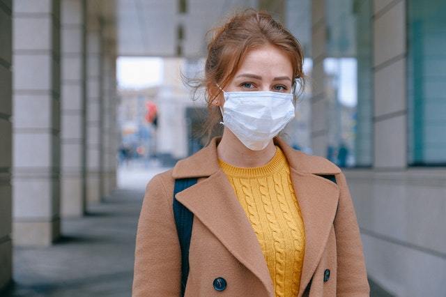 girl in mask on the street from pandemic covid19