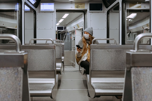 girl alone sits on public transport through pandemic covid 19 eat on maiden voyage